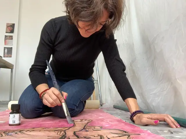 Rania painting on the floor