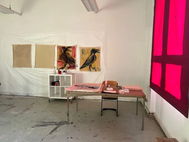 The studio, with crows on the wall and the pink window