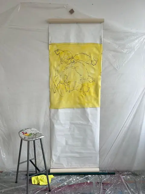 A scroll begins: cats drawn on yellow