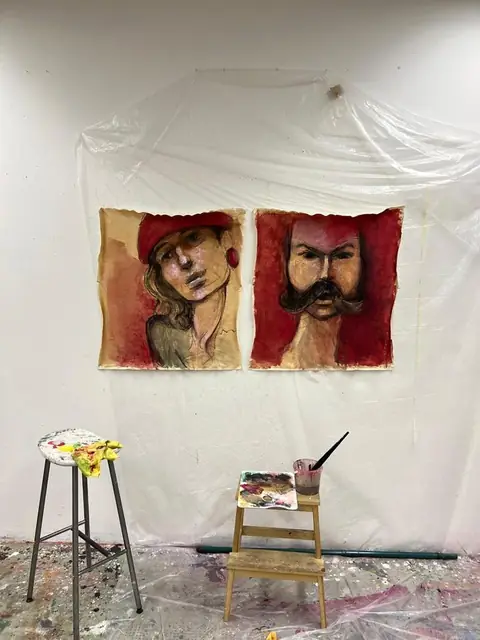 Two portraits in red on unstretched canvas