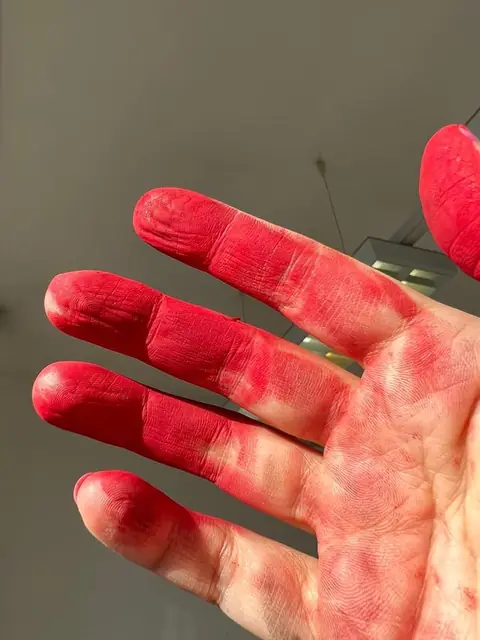 Hands red with pigment
