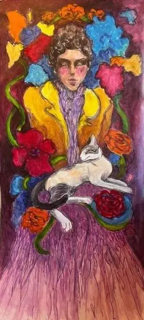 A woman with a sleeping cat among flowers