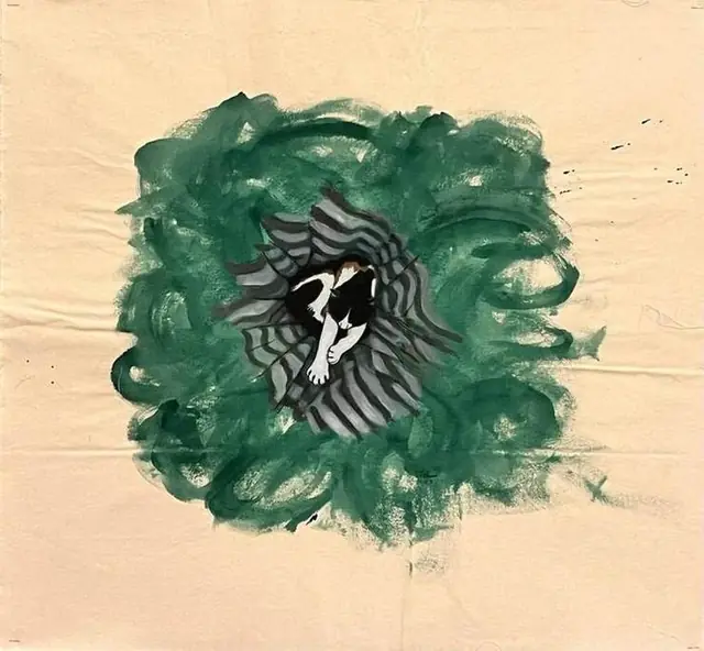 A cat curled up in green
