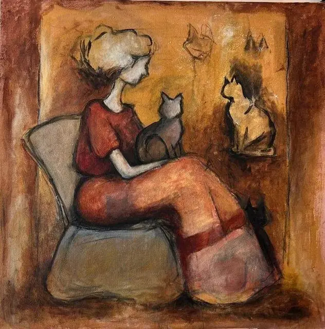 A woman in an armchair with her cats