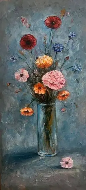 Wildflowers in a glass vase, on blue