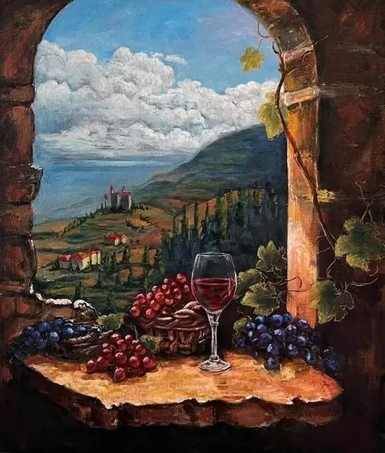 Grapes and a glass of wine in a stone window, above the hills