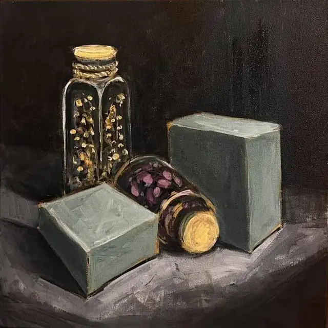 Green boxes and glass jars of dried flowers