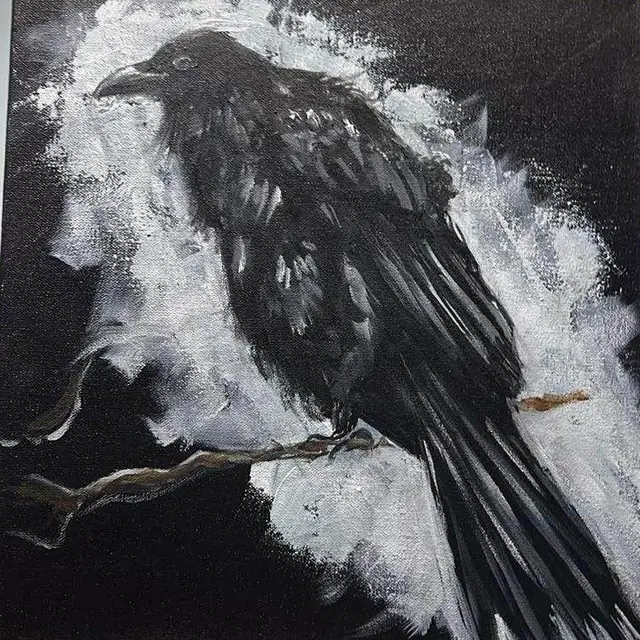 A crow on a branch, black on white