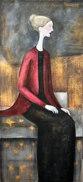 A woman in a red cardigan, seated on gold