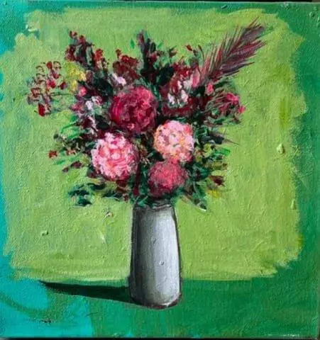 A bouquet in a white vase, on green