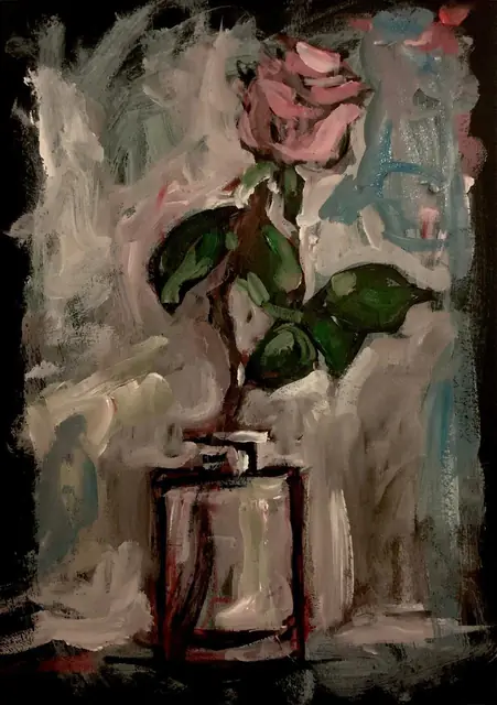 A pink rose in a glass, on grey