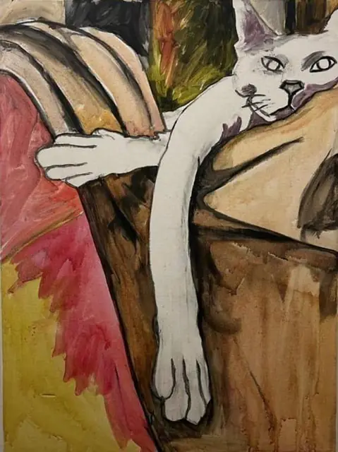 A white cat draped over the sofa