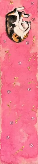 A calico cat curled up on a pink scroll