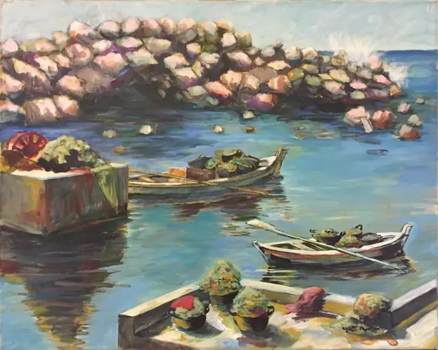 Boats in a small harbour by the rocks