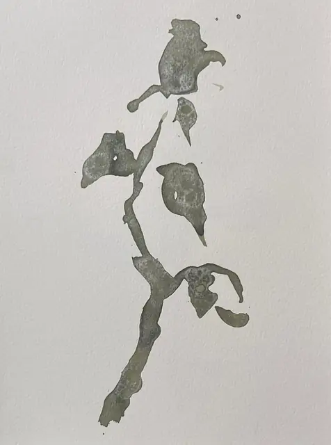 A rose stem in grey-green ink