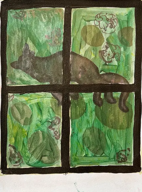 A dark cat seen through a window of green panes