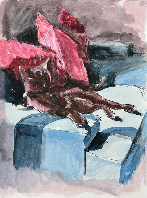 A brown cat stretching on a blue chair with pink cushions