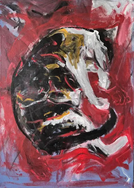 A calico cat curled up asleep, on red