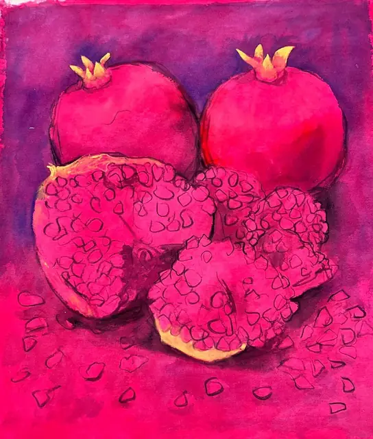 Whole and broken pomegranates on magenta and violet