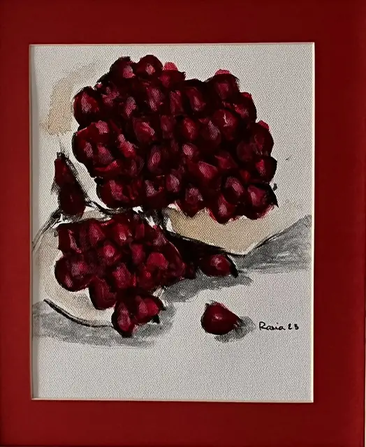 Clusters of pomegranate seeds on white