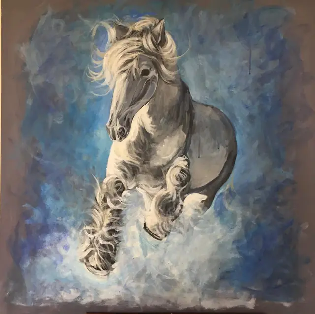 A white horse leaping through blue mist