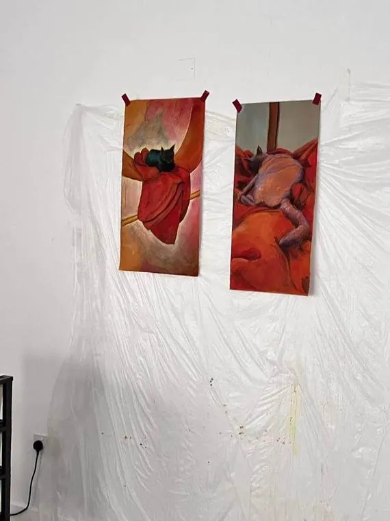 Two tall cat paintings side by side