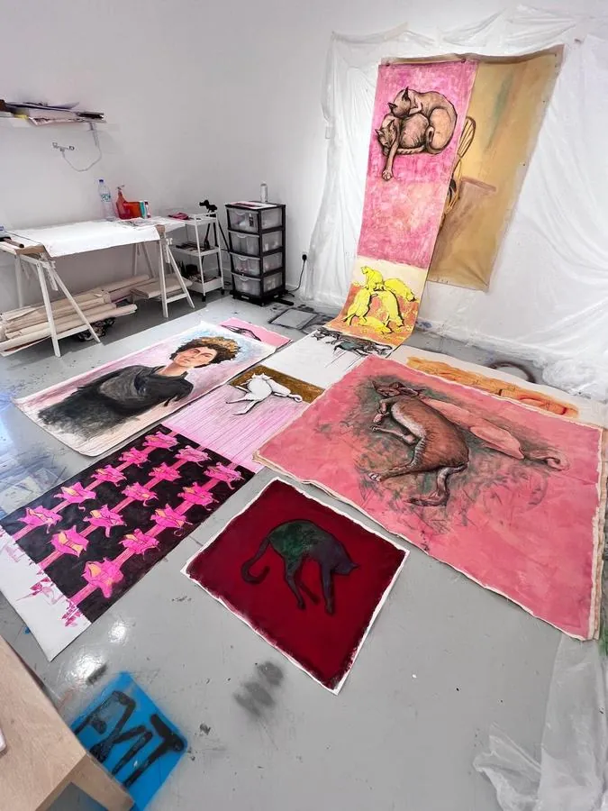 Large works on paper laid out on the studio floor