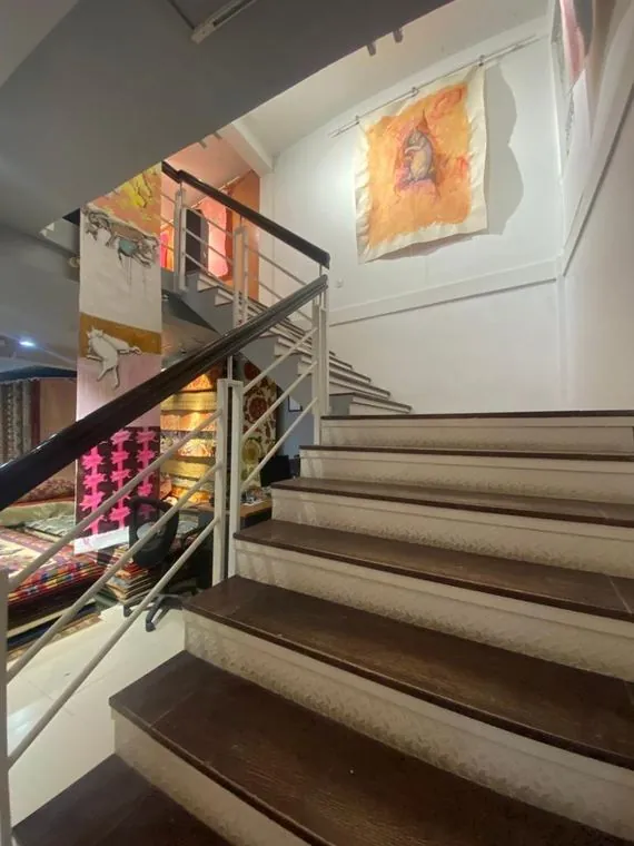 Rania's scrolls hanging along the gallery staircase