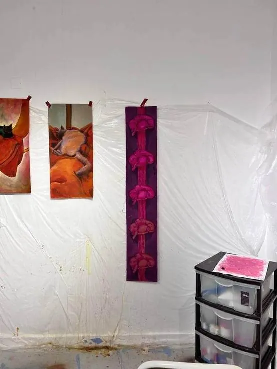 Orange cats and the pink scroll on the wall