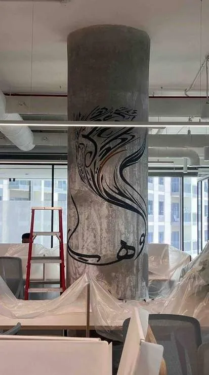 A flowing script wrapping around the pillar