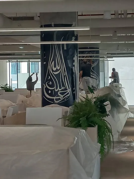 Painting the columns across the open-plan office